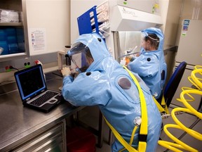 Researchers work in the National Microbiology Laboratory for Zoonotic Diseases and Special Pathogens of the Public Health Agency of Canada (PHAC) in Winnipeg, Manitoba, where the ZMapp antibody "cocktail" was created to fight Ebola.