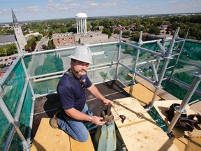 Tom Plue, Historical Restoration Consultant with Sky-High Restoration in Colborne, Ont., is seen at the very top of St. Andrew's Presbyterian Church in Belleville, Ont. where the old church's weather vane used to stand at about 142 feet off the ground during a major exterior restoration project Wednesday, Aug. 27, 2014. - JEROME LESSARD/THE INTELLIGENCER/QMI AGENCY