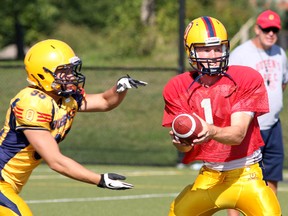 Fifth year quarterback Billy McPhee hands off to running back Alex Cho during  Queen's Golden Gaels practice at Queen's West Campus. Ian MacAlpine/Kingston Whig-Standard