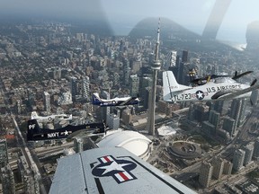 "Skydoc" Ralph Glasser M.D. pilots his T-28 with The Trojan Horsemen Flight Demonstration Team over Toronto August 28, 2013 ahead of the Toronto International Airshow.  (Dave Abel/Toronto Sun)