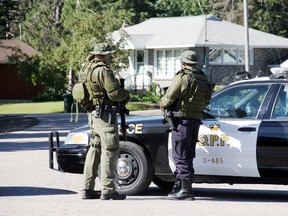 Members of the Ontario Provincial Police Emergency Response Team man a roadblock at the corner of Labine Crescent and Hoffman Street in Petawawa on Aug. 29, 2014. (SEAN CHASE/QMI AGENCY)