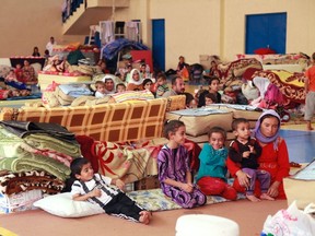 Displaced people from the minority Yazidi sect, fleeing violence in the Iraqi town of Sinjar west of Mosul, take refuge at Dohuk province, August 29, 2014. (REUTERS/Ari Jalal)