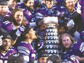 The Western Mustangs celebrate after defeating the Queen’s Gaels 51-22 at last November’s 106th Yates Cup at TD Stadium in London, Ont. Western clearly is the team to beat again this season. (Craig Glover/QMI Agency file)
