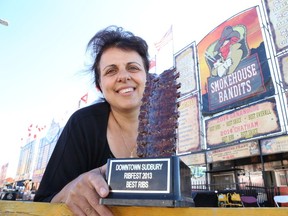 Gino Donato/The Sudbury Star
Anastasia Sakellis of Smokehouse Bandits shows off the best ribs award she won at last year's Downtown Sudbury Ribfest. The event continues today from 11 a.m. to 10 p.m. and Sunday from 11 a.m. to 6 p.m.