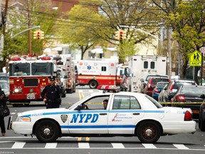 NYPD officers stand near the scene of a derailed F train in Woodside, New York, in this May 2, 2014 file photo. (REUTERS/Eduardo Munoz)