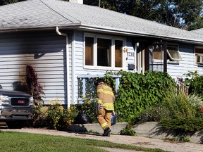 Fire Investigators on scene at a fatal fire on 156 st and 92 ave in Edmonton, Alberta on August 30, 2014. A man was declared deceased at the home. Perry Mah/Edmonton Sun/QMI Agency
