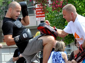 UFC lightweight Chad Laprise (left) trains with former UFC featherweight contender Mark Hominick at Covent Garden Market in London, Ont. August 30, 2013. The training demonstration was part of the UFC Experience Tour, which made a stop in London August 29 and 30. CHRIS MONTANINI\LONDONER\QMI AGENCY