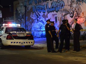Toronto Police investigate an assault on Bloor St. W. near Ossington Ave. on Aug. 30, 2014. (Andrew Collins/Special to the Toronto Sun)