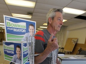 Al Bowman, Brian's father, helps move signs around the the Bowman campaign headquarters on Portage Ave. Aug. 30.