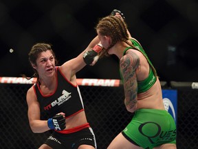 Bethe Correia (left) lands a head shot on Jessamyn Duke during the second round  in UFC 172 at Baltimore Arena. Correia defeated Duke by judges decision on Apr 26, 2014 in Baltimore, MD, USA. (Tommy Gilligan/USA TODAY Sports)