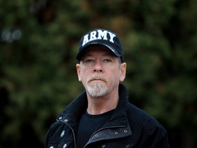 Adrian Lutz poses for a photo in the backyard of his home, 7620 - 75 Ave., in Edmonton Alberta, Alta., on Saturday Nov. 2, 2013. Lutz who suffers from PTSD, served 10 years with the 3rd and 2nd Battalions of the Royal Canadian Regiment.  David Bloom/Edmonton Sun/QMI Agency