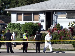 Fire Investigators on scene at a fatal fire on 156 st and 92 ave in Edmonton, Alberta on August 30, 2014. A man was declared deceased at the home. Perry Mah/Edmonton Sun/QMI Agency