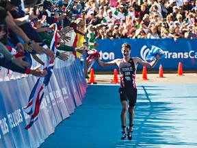 Great Britain's Alistair Brownlee greets fans as he approaches the finish in first place during the 2014 ITU World Triathlon Grand Final Edmonton elite men's race at Hawrelak Park in Edmonton, Alta., on Sunday, Aug. 31, 2014. Codie McLachlan/FILE PHOTO
