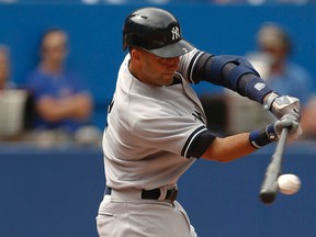 Yankees Derek Jeter connects for a single in the first inning of Sunday's game against the Toronto Blue Jays at the Rogers Centre in Toronto. (Jack Boland/QMI Agency)