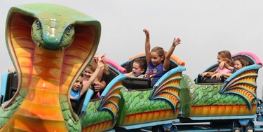 Sunday, Aug. 31, 2014 Ottawa -- Children scream as they approach one of the curves in a cobra roller coaster during the annual Gatineau Hot Air Balloon festival on Sunday, Aug. 31, 2014. The festival continues Monday.
DOUG HEMPSTEAD/Ottawa Sun/QMI AGENCY