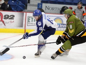 Sudbury Wolves veteran centre Jacob Harris gets stopped by North Bay Battalion goaltender Evan Cormier while North Bay's Riley Brace trails the play during OHL exhibition action at Sudbury Community Arena on Sunday afternoon.