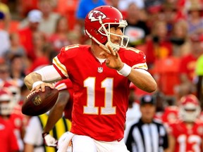 Alex Smith of the Kansas City Chiefs drops back to pass against the Minnesota Vikings defense during the first quarter at Arrowhead Stadium on August 23, 2014 in Kansas City, Missouri.  (Jamie Squire/Getty Images/AFP)