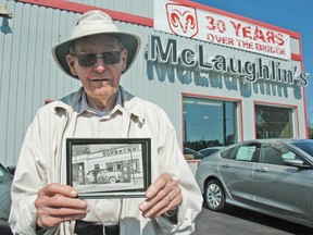 Harold McLaughlin has been in the automotive industry for 65 years. Although now 91, and officially retired, the former owner of McLaughlin's Chrysler Jeep in Mitchell still shows up for work every day. He holds a photo of his early days in the industry, taken in Listowel in 1951.  KRISTINE JEAN/MITCHELL ADVOCATE