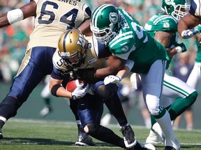 Bombers QB Drew Willy gets sacked during the Labour Day Classic. (DAVE STOBBE/Reuters)