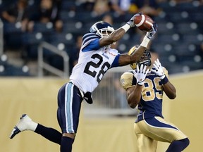 Argonauts defensive back Brandon Underwood (left) intercepts a pass earlier this season. The former Super Bowl winner with the Green Bay Packers mysteriously failed to show up for practice Saturday, the final workout before the Labour Day Classic. (Reuters)