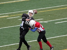 Sarnia Minor Athletic Association football will be kicking off its 57th season on Wednesday, September 3 at Norm Perry Park. Pictured is Mammoths' quarterback Travis Conrad (in black) geting hit by Toros' defender Nathan Greaves while throwing a pass in the first quarter of their SMAA football semi finals on Saturday, Oct. 26, 2013. SHAUN BISSON/THE OBSERVER/QMI AGENCY