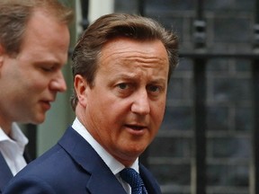 Britain's Prime Minister David Cameron walks to Parliament after leaving Number 10 Downing Street in London September 1, 2014.  Cameron will announce new laws on Monday to try to stop radicalised Britons returning from Syria and Iraq launching attacks on British soil, after a video purportedly showed a London-accented man beheading a U.S. journalist.  (REUTERS/Luke MacGregor)