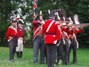 Major General Isaac Brock (Bob Rennie), second from left, watches as members of the Royal Scots Regiment demonstrate the firing of their flintlock muskets during a special War of 1812 presentation at the Ingersoll Museum in Ingersoll, Ont., June 27, 2014. (JENNIFER VANDERMEER/QMI AGENCY)
