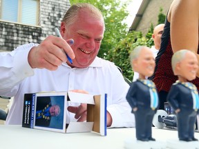 Mayor Rob Ford presides over the sale of bobbleheads at his mother's Etobicoke home. (DAVE ABEL, Toronto Sun)