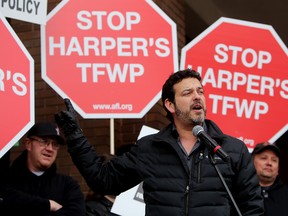 Alberta Federation of Labour president Gil McGowan speaks to the crowd during a protest of the Temporary Foreign Workers program, outside Canada Place, in downtown Edmonton, March 29, 2014. (David Bloom/QMI Agency)