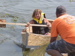 Eight-year-old Aubrey Wood crosses the finish line to win the 2nd annual Build a Boat by the Bay race Saturday afternoon at Bayfest in Port Rowan, sponsored by Port Rowan Home Building Centre.