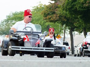 A couple of the Shriners zip back and forth across the street as part of the Labour Day parade on Front Street Monday. (BRENT BOLES, The Observer)