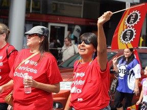 PSAC members dance and sign along to Takin' Care of Business as they march along Elgin St. in Ottawa during the annual Labour Day parade, Monday, Sept. 1, 2014. 
DOUG HEMPSTEAD/Ottawa Sun/QMI Agency