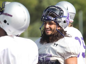 Western Mustangs running back Garrett Sanvido laughs during practice at TD Stadium last week. His brother also plays for the same team as a receiver. (DEREK RUTTAN, The London Free Press)