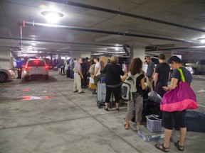Huge lineups form in the garages beneath the Luxe student building on Richmond St. as Western students move in Monday.  (MIKE HENSEN, The London Free Press)