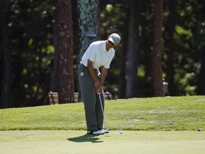 U.S. President Barack Obama lines up his putt while playing a round of golf at Farm Neck Golf Club in Oak Bluffs on Martha's Vineyard, Massachusetts August 9, 2014. REUTERS/Kevin Lamarque