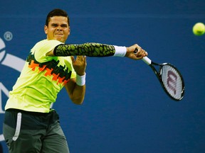 Milos Raonic hits a return shot to Kei Nishikori during their men's singles match at the U.S. Open in New York, Sept. 1, 2014. (ADAM HUNGER/Reuters)
