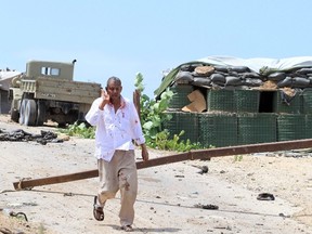 An unidentified man walks away from the Parliament during an attempted attack by Al-Shabaab militants in the capital Mogadishu in this file photo from May 24, 2014. (REUTERS/Omar Faruk)