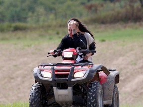 Justin Bieber and Selena Gomez ride an all-terrain vehicle on the backroads near Stratford, Ont. where Bieber grew up, on Friday Aug. 29, 2014. (Pacific Coast News/QMI Agency)