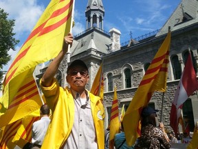 Protesters gathered at the human rights memorial at Ottawa City Hall on Tuesday, Sept. 2, 2014 to oppose the city raising the flag of the Socialist Republic of Vietnam on its independence day. JON WILLING/OTTAWA SUN