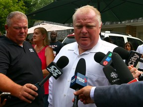 Mayor Rob Ford signs bobbleheads at his mother's house in Etobicoke Monday, Sept. 1, 2014. (Dave Abel/Toronto Sun)