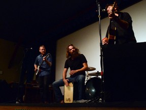 Devon Bjarnason (R), frontman for Devon Coyote, along with bassist and banjo player D’Arcy Booth and percussionist Rod Anderson, rocked the Waterton Opera House on Aug. 22 and had people’s ears yearning for more. John Stoesser photos/QMI Agency