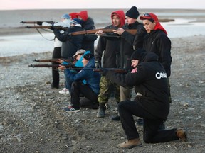 Canada's Prime Minister Stephen Harper (front) shoots a .303 Lee-Enfield rifle while taking part in a demonstration by the Canadian Rangers at a camp near the Arctic community of Gjoa Haven, Nunavut August 20, 2013. (REUTERS/Chris Wattie)