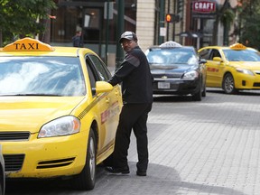 Taxi drivers wait outside the Westin Hotel, 10135 - 100 St., in Edmonton Alta., on Tuesday Sept. 2, 2014. David Bloom/Edmonton Sun