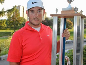 Brennan Smith holds the winner’s trophy after capturing the 74th Whig-Standard Eastern Ontario golf championship on the first playoff hole Aug. 9 at Cataraqui Golf and Country Club. (Julia McKay/The Whig-Standard)