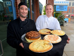 Sous Chef Michael Schuster, left, and Ryan Watson, Western Fair executive chef, show five of the pies that will be featured during the Western Fair. (MORRIS LAMONT, The London Free Press)