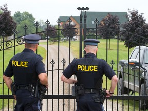 Perth County OPP officers stand at the front gates of Justin Bieber?s father?s estate northeast of Stratford Tuesday. Within minutes of media arriving in front of the estate, police arrived. (CRAIG GLOVER, The London Free Press)