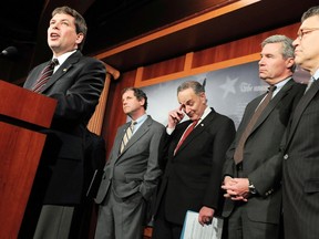 U.S. Senators Mark Begich (D-AK), Sherrod Brown (D-OH), Charles Schumer (D-NY), Sheldon Whitehouse (D-RI) and Al Franken (D-MN) (L-R) give a news conference. (REUTERS/Jonathan Ernst)