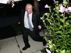 Toronto Mayor Rob Ford running door to door canvassing in the Jane-Finch area in Toronto on Tuesday, September 2, 2014. (Craig Robertson/Toronto Sun)