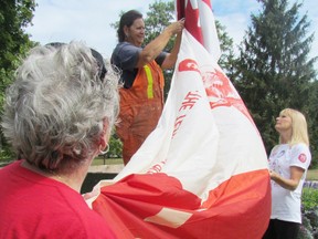 This file photo from 2013 shows Coleen Coyle, with the city parks department, preparing to raise a Terry Fox Run flag at Canatara Park, with help from run committee members Jo Kulik, left, and Laurie Rome. This year's Terry Fox Run is Sept. 14 at the Terry Fox Loop in Canatara Park. (FILE PHOTO/ THE OBSERVER/ QMI AGENCY)