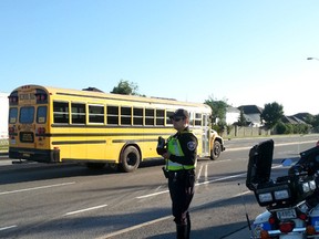 Ottawa Police Const. Steve Coulthart uses a radar device on Innes Rd. during a school zone blitz on Wed. Sept. 3, 2014. Police issued 77 tickets in three hours. KELLY ROCHE/OTTAWA SUN/QMI AGENCY